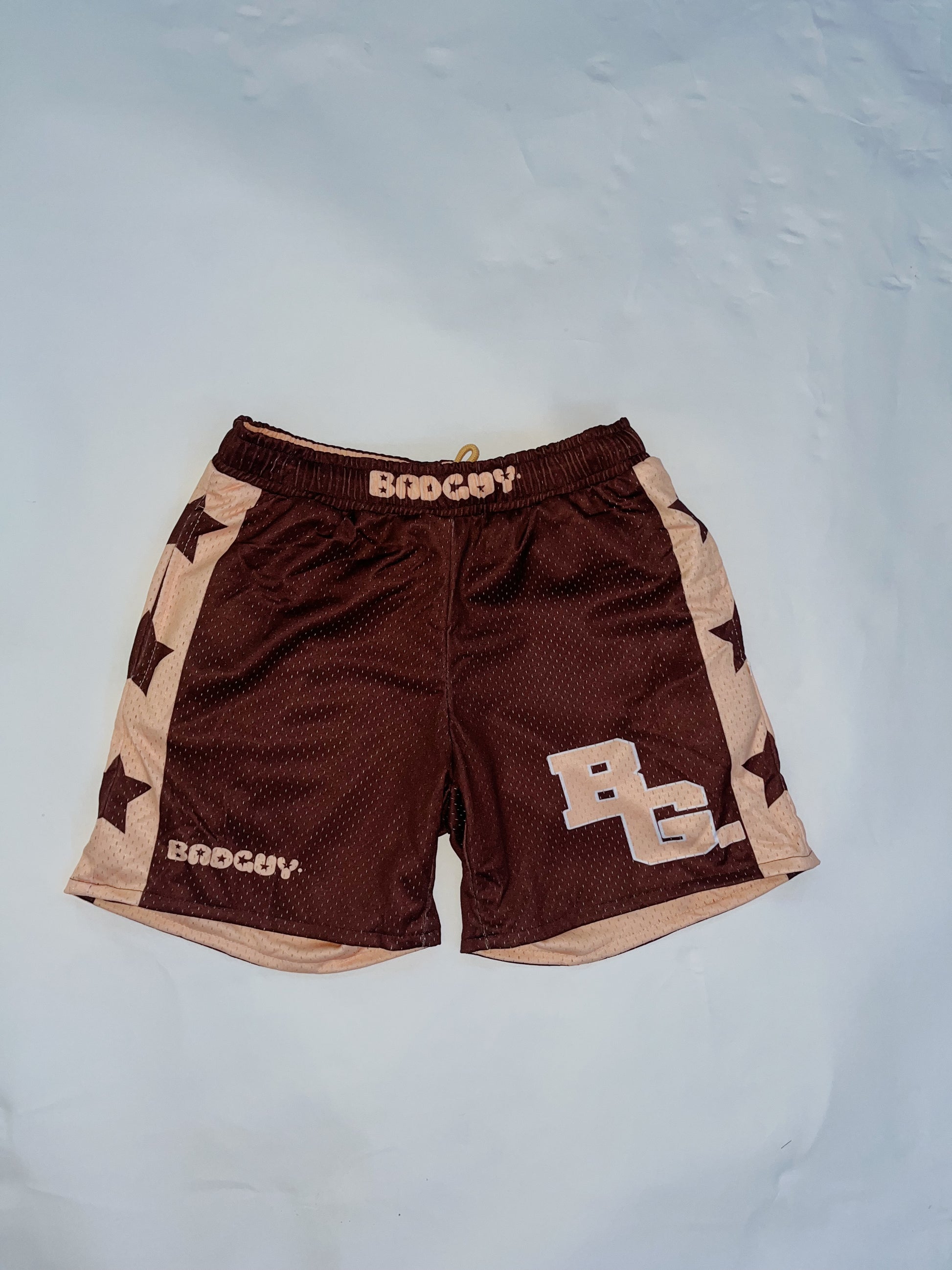 Reversible Allstar 2.0 Mesh Shorts in peach beige and brown with bold star designs, featuring an elastic waistband and practical pockets, suitable for men and women, ideal for basketball and workouts.