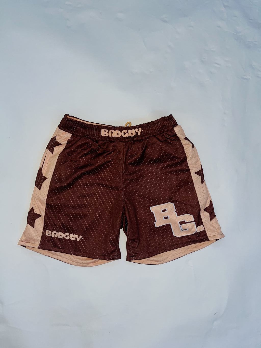 Reversible Allstar 2.0 Mesh Shorts in peach beige and brown with bold star designs, featuring an elastic waistband and practical pockets, suitable for men and women, ideal for basketball and workouts.